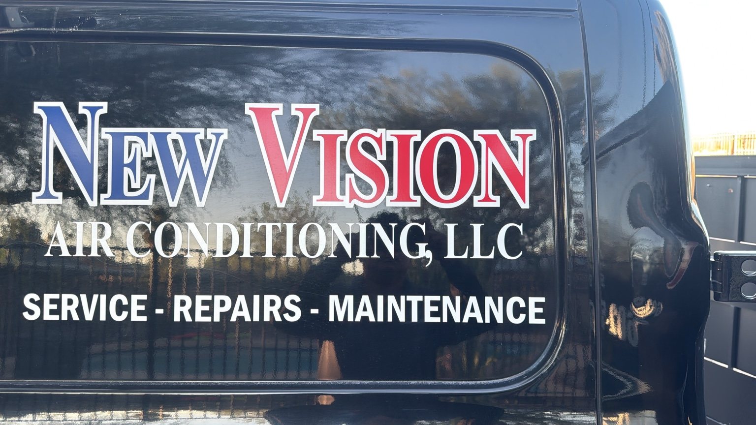 New Vision Air Conditioning LLC branding on company vehicle